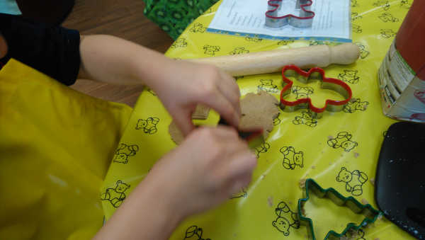 Young person cutting biscuits in pastry